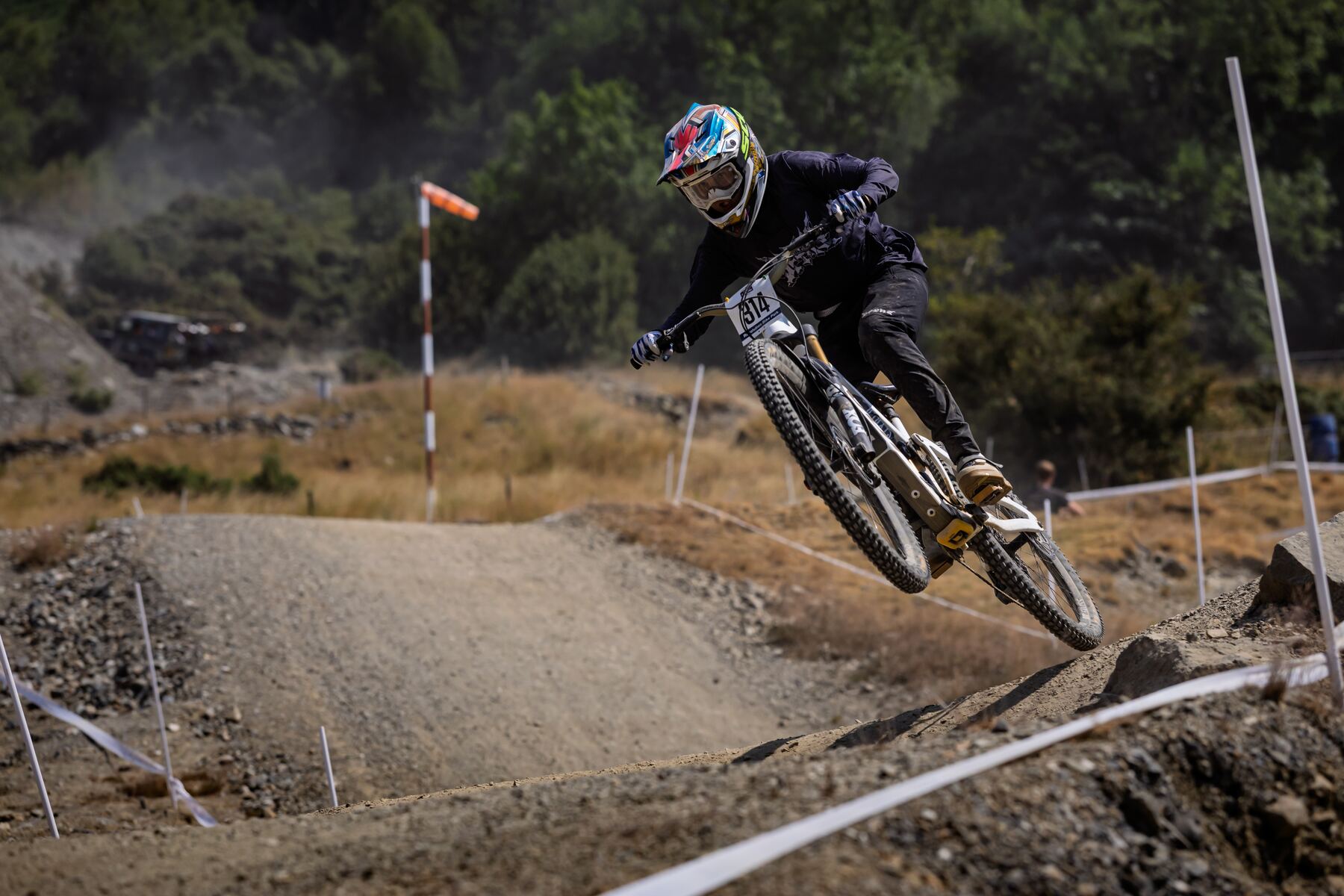 Stanlie Britt racing bib 314 airborne on a downhill run